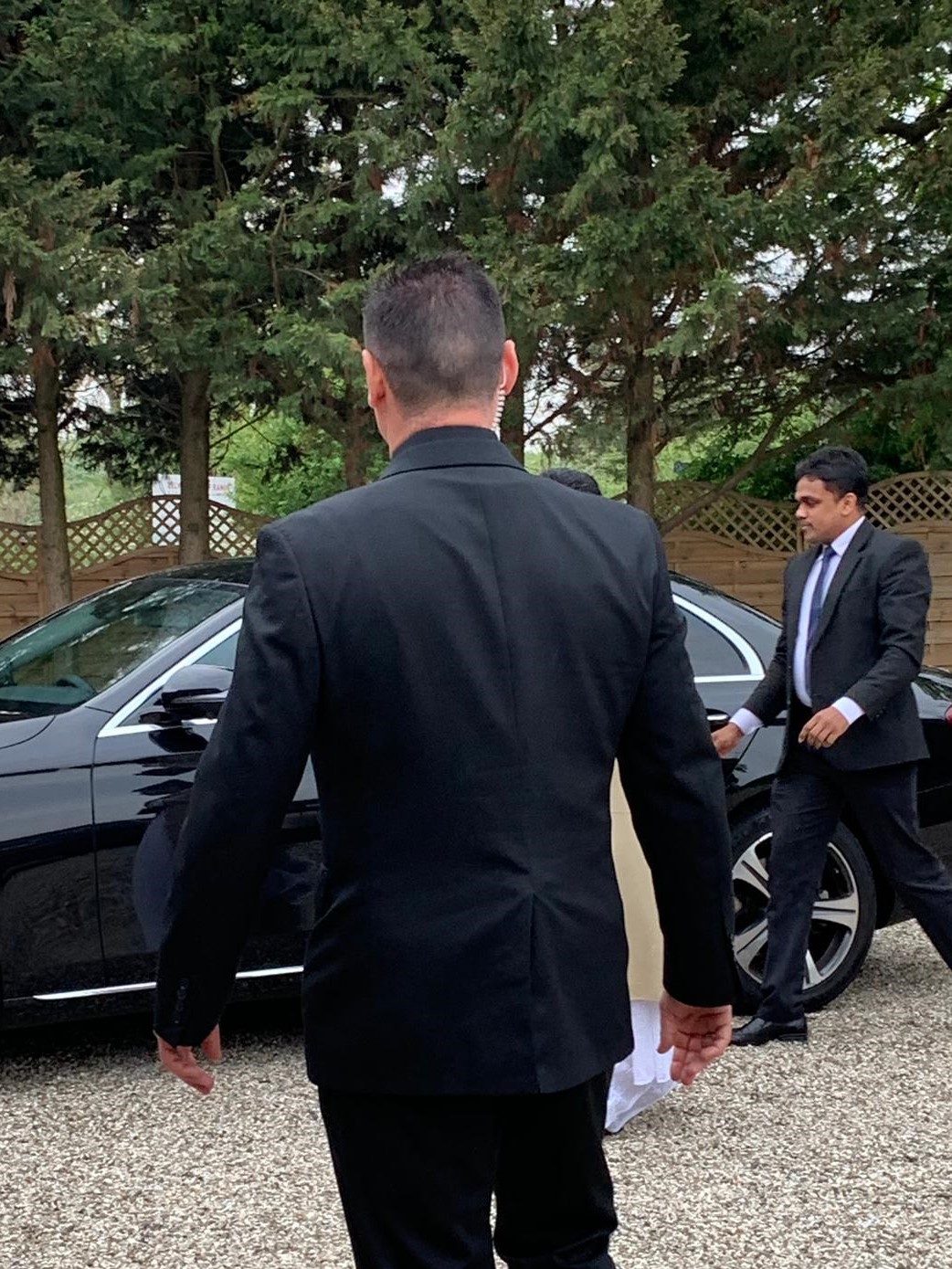 VIP Security Services Close Protection agents, entering car. 