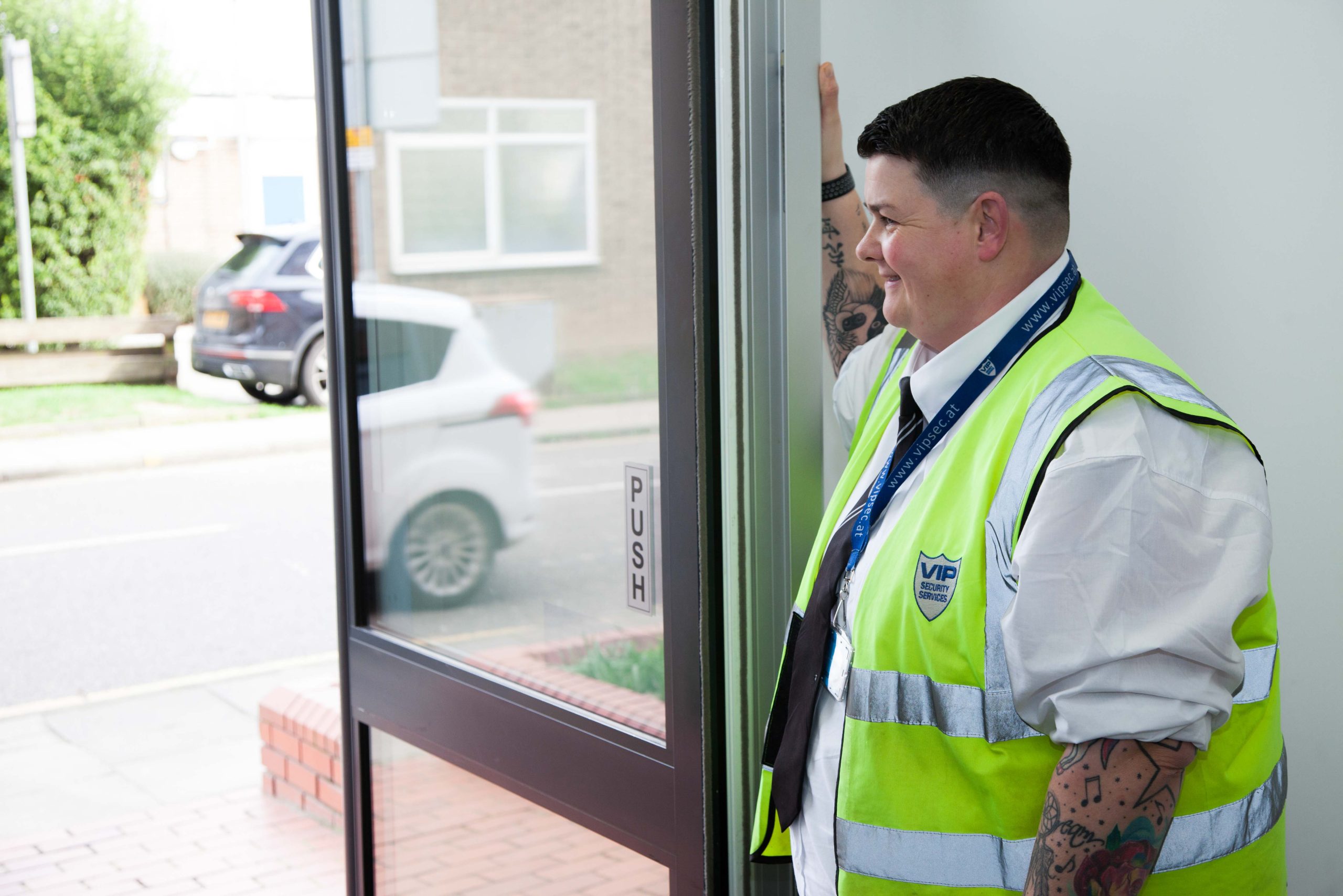 VIP Security Services officer, standing by open door.